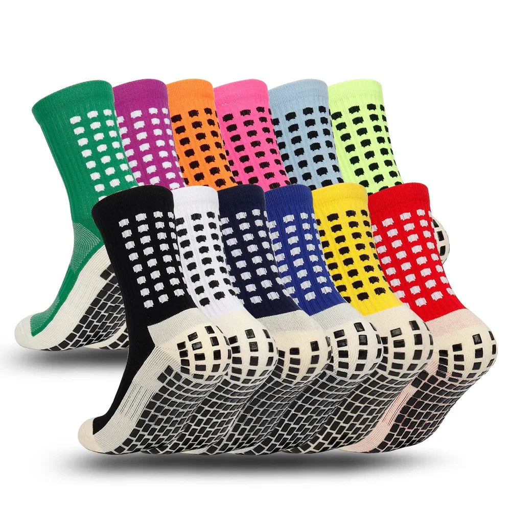 A variety of brightly colored performance sports grip socks displayed in a row.