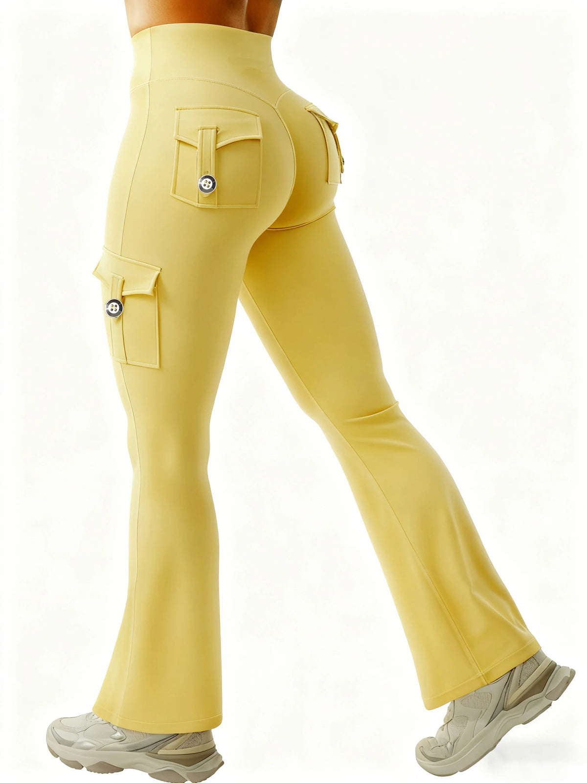 A model is wearing yellow high-waisted flared fitness pants with flap pockets.
