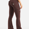 A model is wearing high-waisted, flared fitness pants in a dark brown color.
