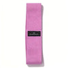 A pink fabric resistance band with a black label for glute and leg workouts.