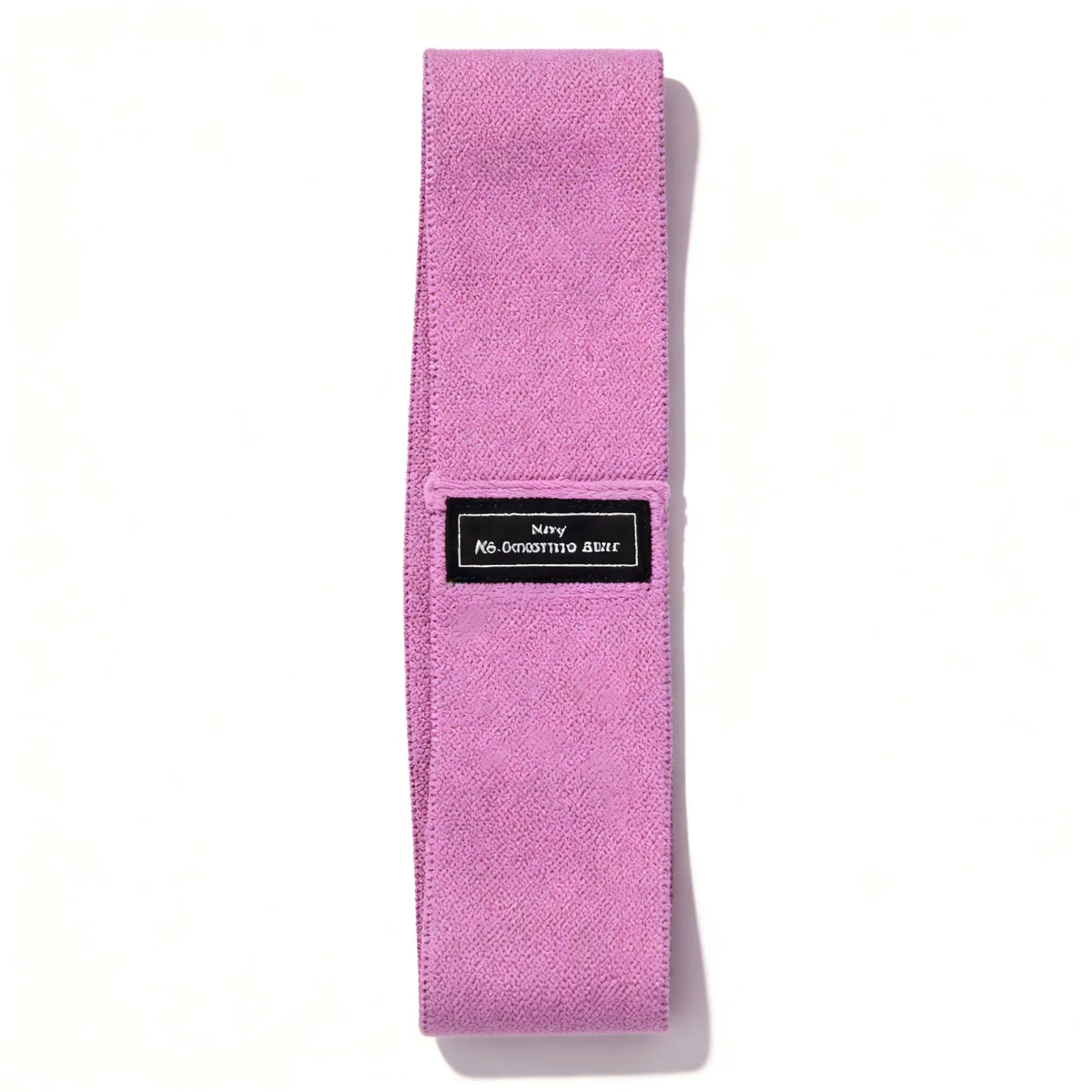 A pink fabric resistance band with a black label for glute and leg workouts.