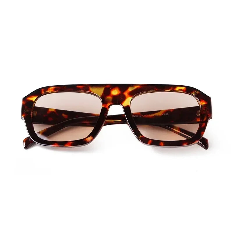 Vintage oversized square sunglasses with a tortoiseshell pattern frame and brown lenses.
