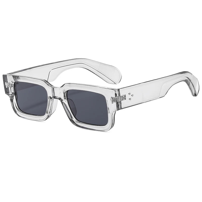 Clear acetate frame sunglasses with dark lenses and rivet details