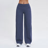 A full-length view of dark blue high-waist wide-leg yoga leggings worn by a person.