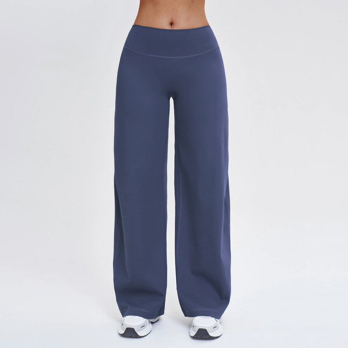 A full-length view of dark blue high-waist wide-leg yoga leggings worn by a person.