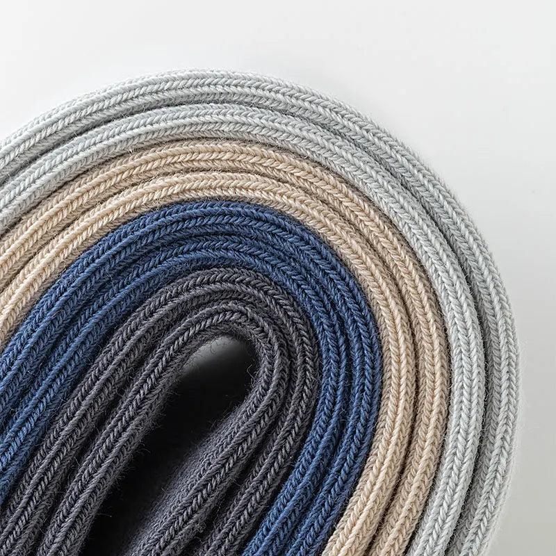 A roll of men's combed cotton socks in various shades of gray and blue.