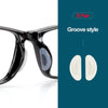 A pair of black silicone groove style eyeglass nose pads shown with a close-up view.