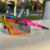 A pair of vibrant, multi-colored sports sunglasses resting on a white surface.