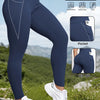 Navy compression fit sports leggings worn by a woman outdoors, highlighting features like pockets and hip lift.