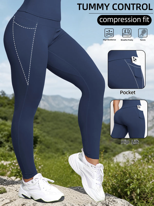 Navy compression fit sports leggings worn by a woman outdoors, highlighting features like pockets and hip lift.
