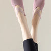 Pair of pink non-slip yoga and gym socks with silicone grip worn on a person's feet.