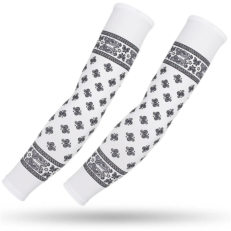 A pair of white sports arm sleeves featuring black paisley and geometric patterns for UV protection.
