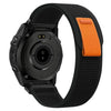A black Garmin sports watch with an adjustable nylon strap shown from the side.