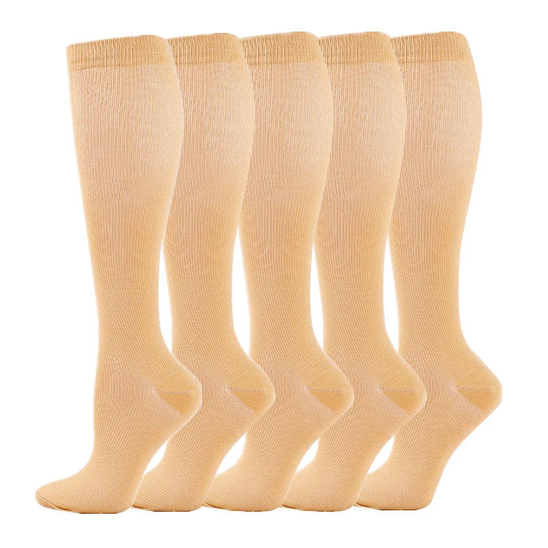A set of beige medical grade compression socks for veins and sports