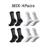 Four pairs of black and white athletic grip socks displayed together.
