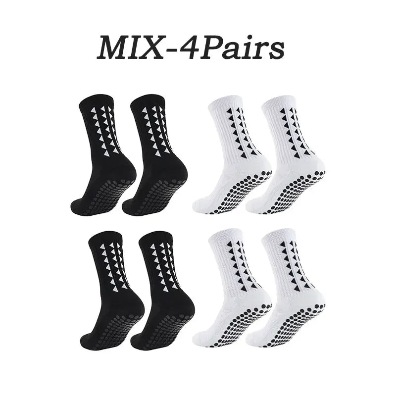 Four pairs of black and white athletic grip socks displayed together.