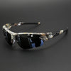 A pair of tortoiseshell patterned wraparound sports sunglasses with dark lenses resting on a dark surface.