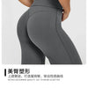 Close-up of a model wearing dark gray high waisted yoga pants highlighting the fit and texture.