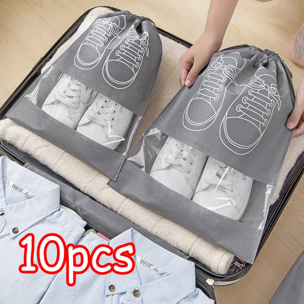 A gray reusable non-woven shoe storage bag with white shoes is shown inside a storage box.