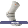A pair of grey men's sport compression socks shown from the side.