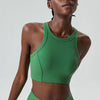 A model wearing a high-impact stretch yoga crop top and matching bottoms in a vibrant green color.