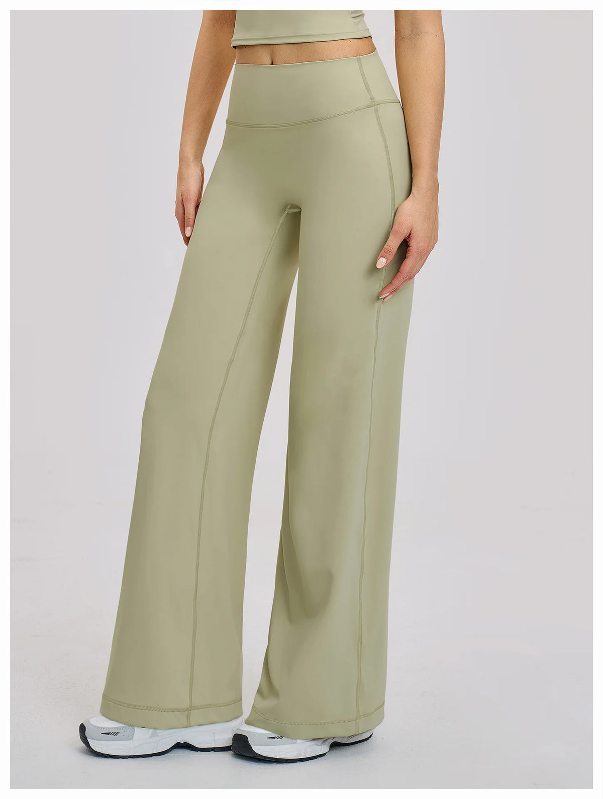A model wearing high-waist wide-leg yoga leggings in olive green.
