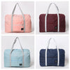 Three versions of a foldable travel duffel bag in pink, maroon, and blue fabric shown from the front.