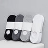 A set of four boat socks in black, gray, and white are displayed on a white surface.