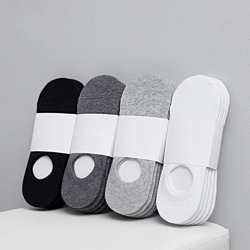 A set of four boat socks in black, gray, and white are displayed on a white surface.