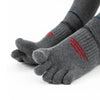 A close-up of a gray men's sport compression sock on a hand and foot, showing red stitching.