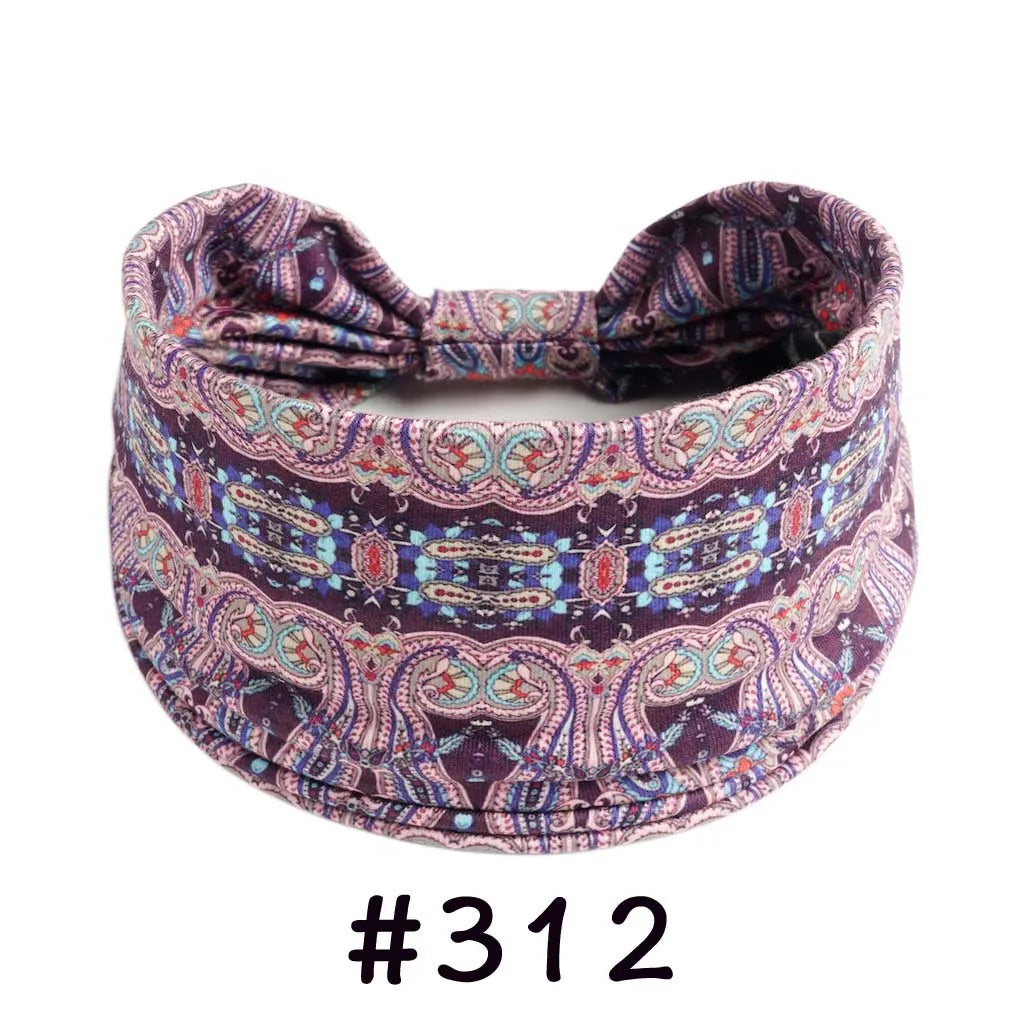 A purple and pink boho knotted cotton headband with intricate paisley patterns.