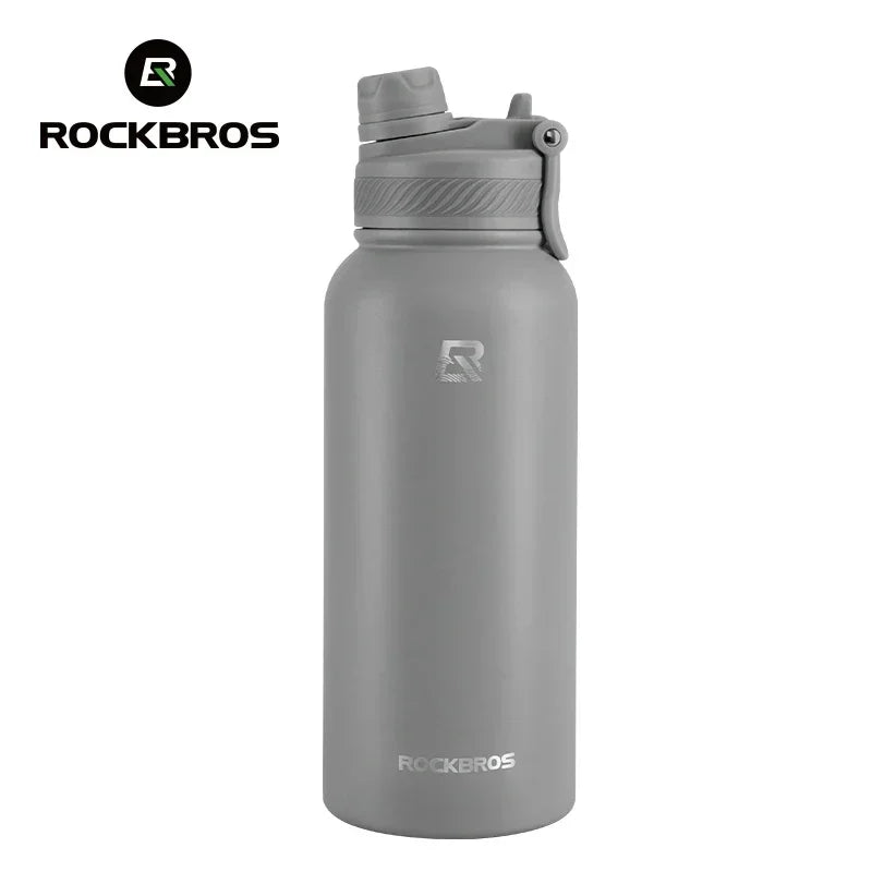 A gray insulated stainless steel thermal water bottle with a silver cap.