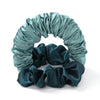 A teal satin heatless curling rod headband with gathered fabric curls.