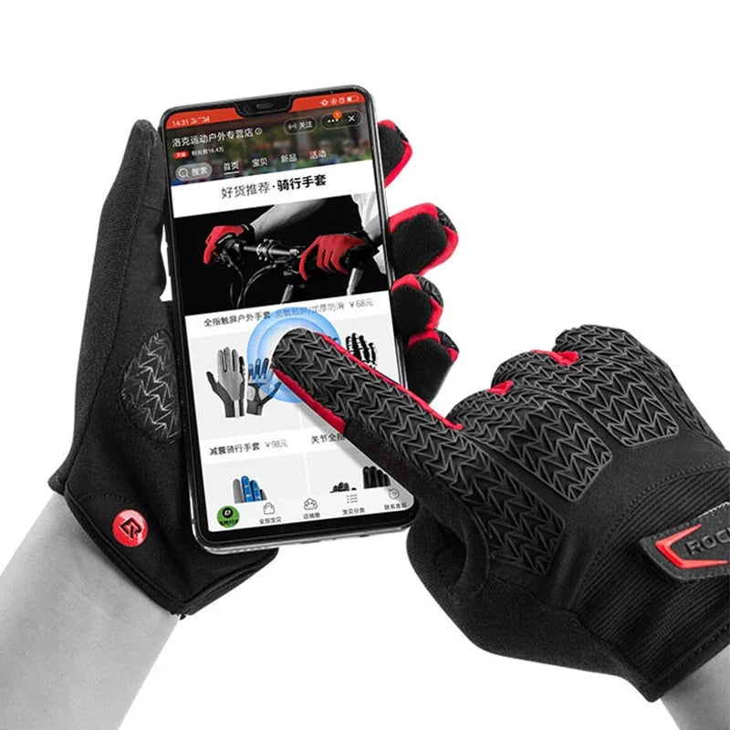 A close-up of black cycling gloves being worn on a hand, with a smartphone displaying instructions.