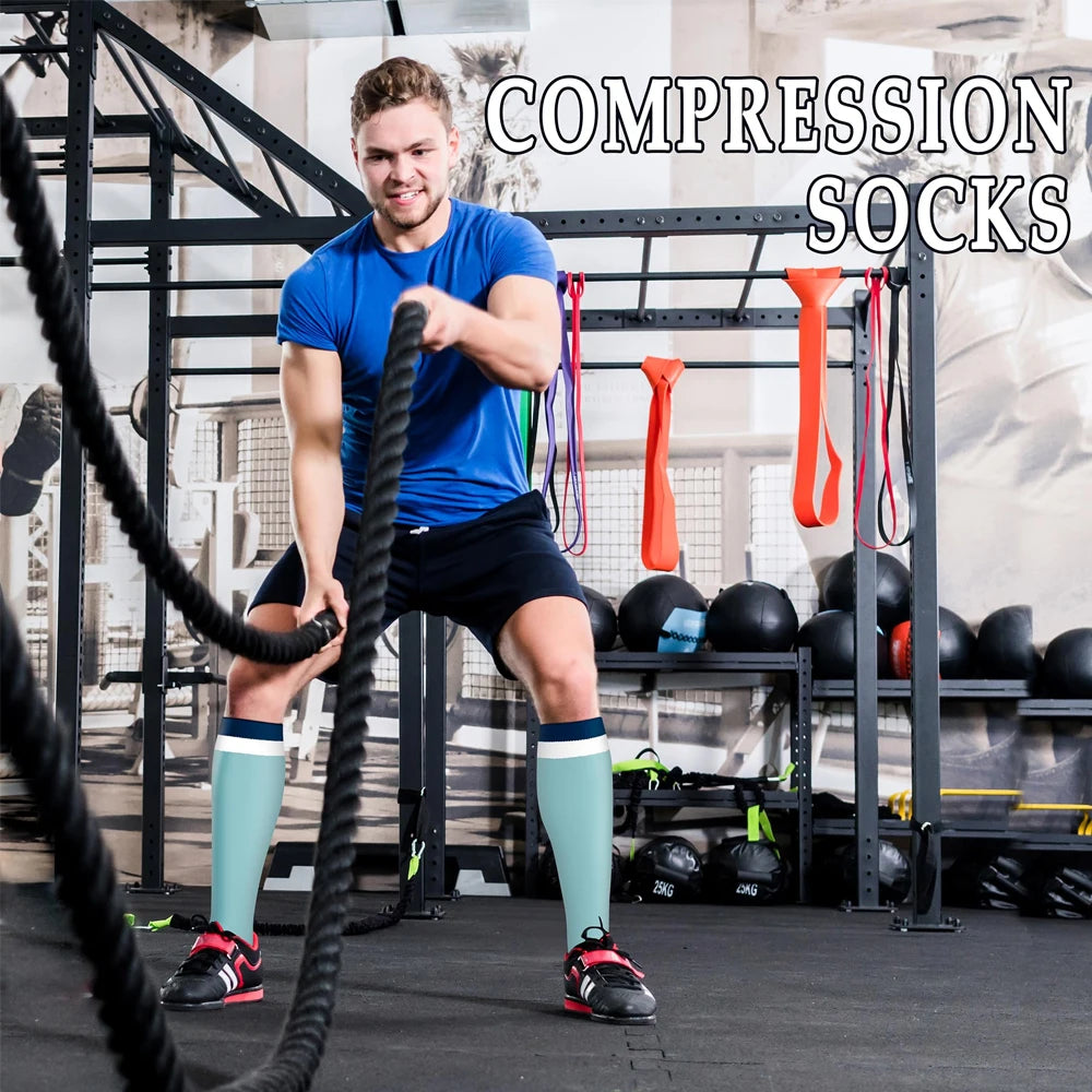 A muscular man wearing compression socks is exercising in a gym setting with various fitness equipment visible.