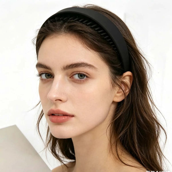 A close-up of a woman wearing black plastic hair bands on her hair.