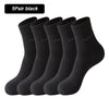 A stack of five black bamboo fiber socks shown from the side.