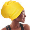 A woman wearing a bright yellow silicone swim cap on her head.