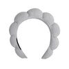 A light gray microfiber skincare headband and wristband set.