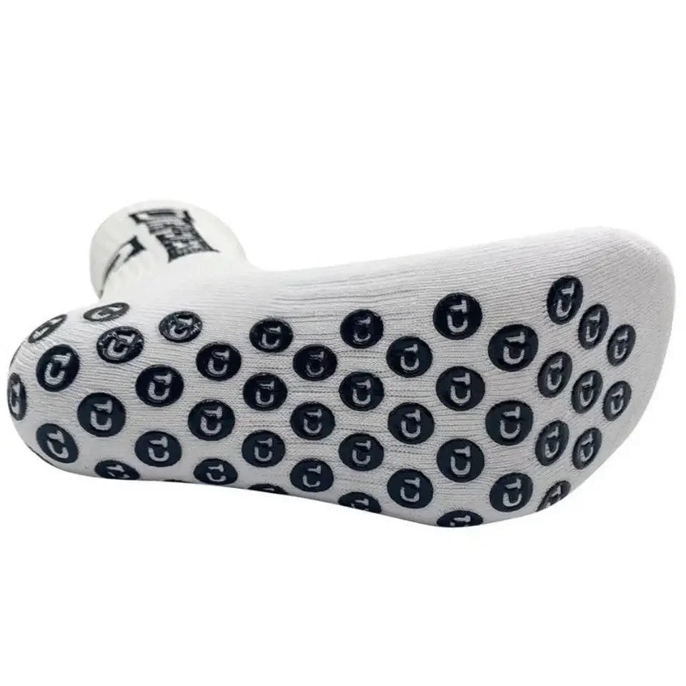 White mid-calf football socks with a repeating black logo pattern.