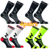 Four pairs of black and gray compression cycling socks shown from the side.