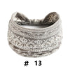 A gray knitted headband with an intricate geometric pattern is shown.