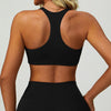 A woman wearing a black padded sport yoga bra and matching bottoms, shown from the back.
