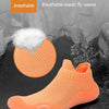 An orange breathable elastic fly weave slip-on shoe shown against a dark background.