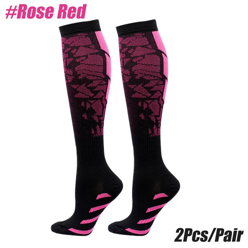 A pair of black and pink patterned sport compression socks.