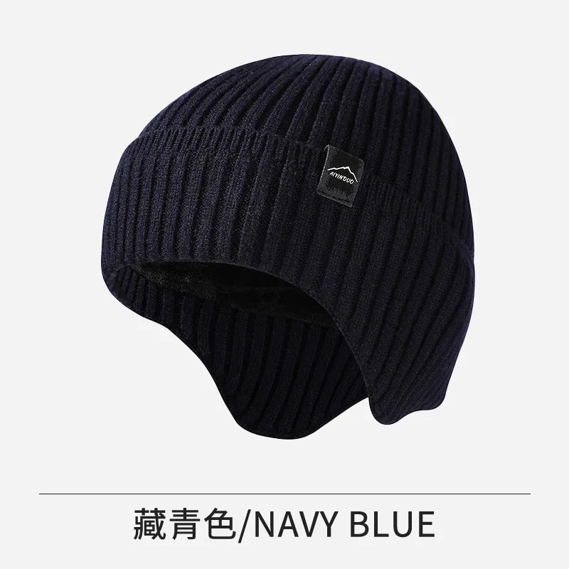 A dark navy blue knitted winter hat shown flat lay.