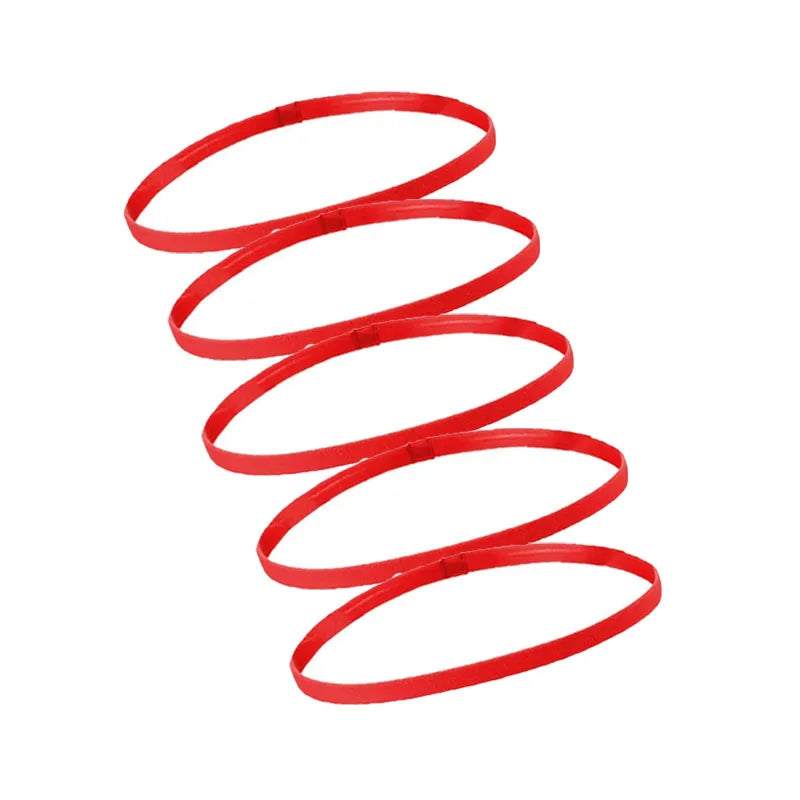 A set of five red elastic sports headbands coiled in a spiral pattern.