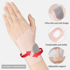 A hand wearing a pink flexible compression wrist guard for joint support, showing its ultra-thin design and adjustable fit.