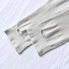 Light gray ribbed arm sleeves folded on a white surface.