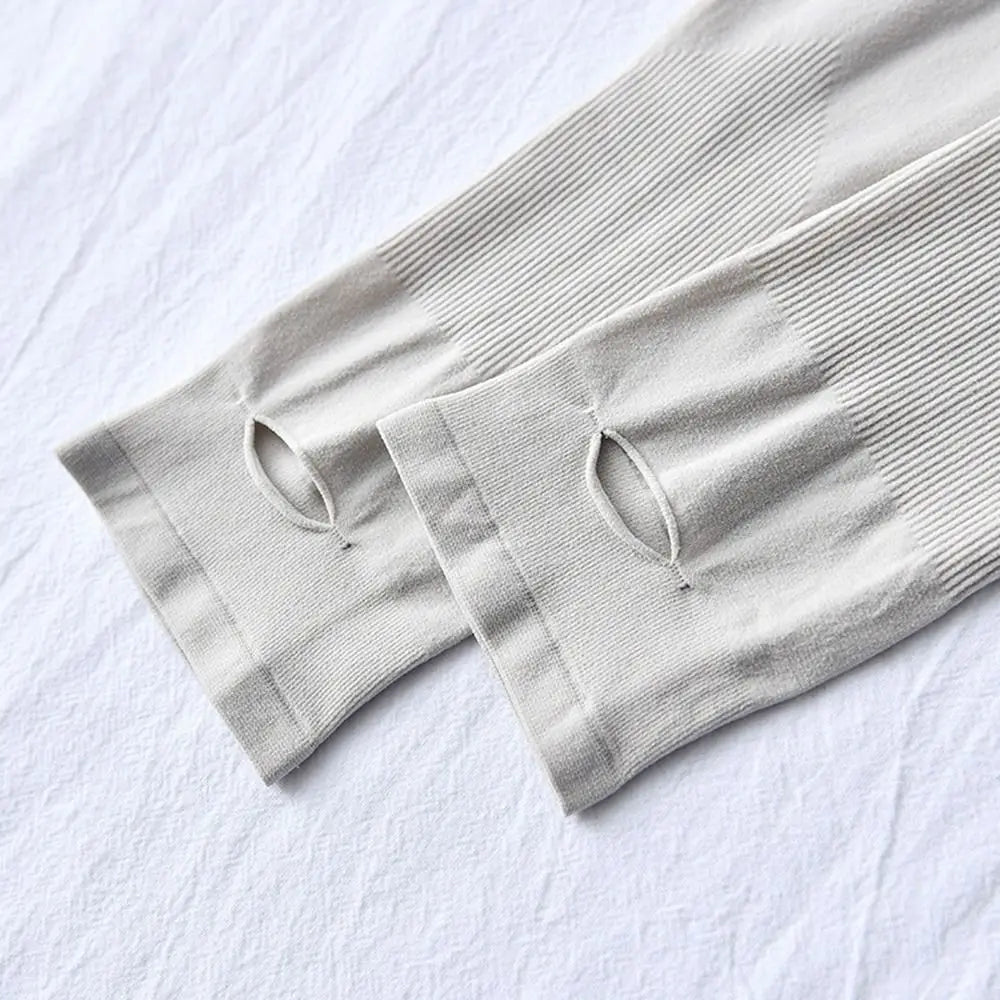 Light gray ribbed arm sleeves folded on a white surface.